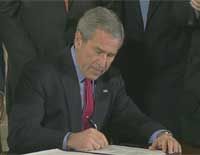 President Bush today signed into law a controversial Bill that permits the tough interrogation of foreign terror suspects and smooths the way for Guantanamo Bay detainees to be tried before military commissions without any legal representation.